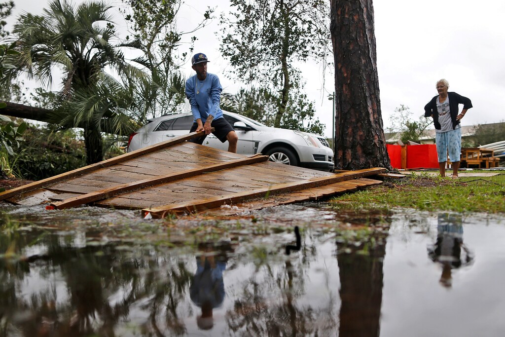 a man clears damaage form a hurricane
