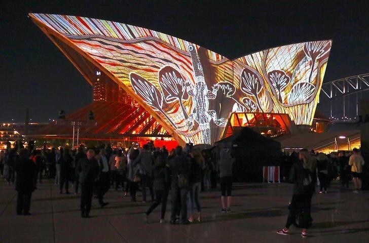 A crowd watches as Australian Aboriginal paintings by six First Nations artists are projected onto the Sydney Opera House as part of the project "Badu Gili 2018", meaning "water light" in the local Aborigine's Gadigal language, in Sydney, Australia, July 24, 2018. REUTERS/David Gray