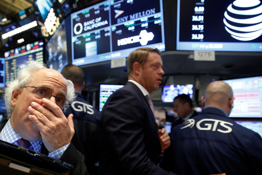 Traders work on the floor near the post where telecoms company AT&T is traded at the New York Stock Exchange (NYSE) in New York City, U.S., October 24, 2016. REUTERS/Brendan McDermid - RTX2Q8E1