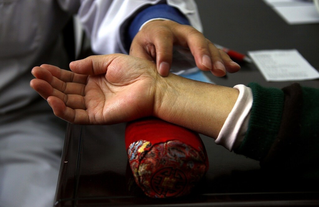 A diabetes patient has her pulse checked by diabetes specialist Doctor Tong Xiao Lin during a medical check-up at the Guanganmen Chinese medicine Hospital in Beijing March 19, 2012. In 30 years, the Chinese people have gone from having barely enough to eat to worrying about chronic diseases like diabetes, leaving the healthcare system struggling with a condition that is rapidly outpacing its ability to keep up. Spending on diabetes reached $25 billion in China in 2010, only 6 percent of the $390 billion spent worldwide. But the rate of diabetes in China is already at the same levels as in the West, leaving doctors, drug companies and policymakers to hunt for low-cost alternatives before the disease swamps the rudimentary healthcare system. Picture taken March 19, 2012. To match Feature CHINA-DIABETES/ REUTERS/David Gray (CHINA - Tags: HEALTH SOCIETY) - RTR2ZUB0
