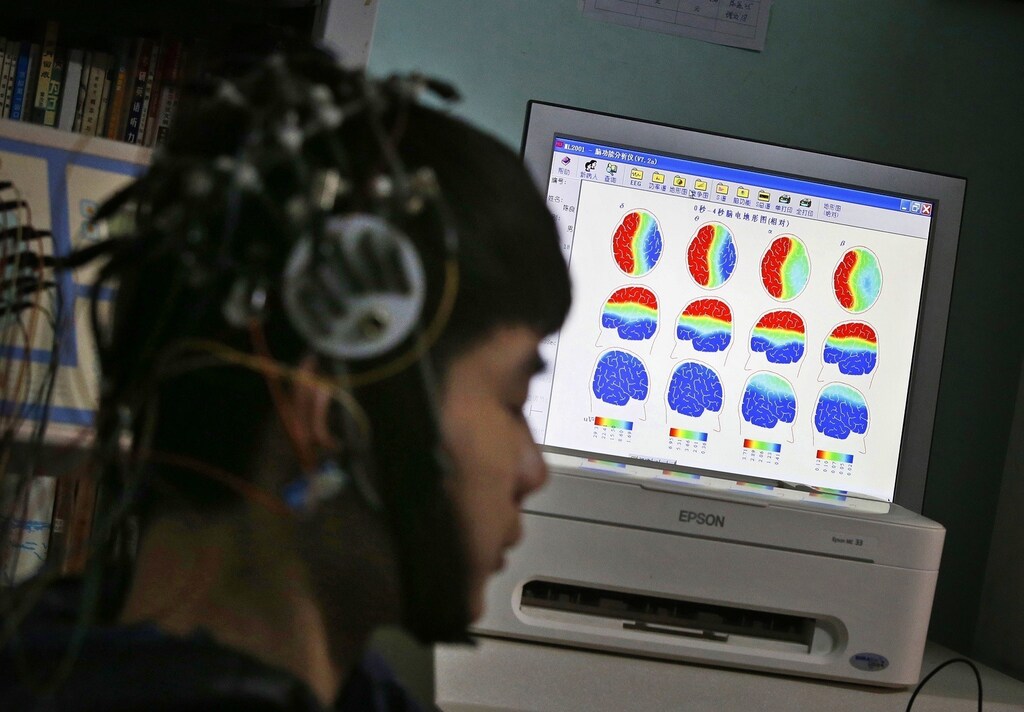 A boy who was addicted to the internet, has his brain scanned for research purposes at Daxing Internet Addiction Treatment Center in Beijing February 22, 2014. As growing numbers of young people in China immerse themselves in the cyber world, spending hours playing games online, worried parents are increasingly turning to boot camps to crush addiction. Military-style boot camps, designed to wean young people off their addiction to the internet, number as many as 250 in China alone. Picture taken February 22, 2014. REUTERS/Kim Kyung-Hoon (CHINA - Tags: SOCIETY)ATTENTION EDITORS - PICTURE 20 OF 33 FOR PACKAGE 'CURING CHINA'S INTERNET ADDICTS'TO FIND ALL IMAGES SEARCH 'INTERNET BOOT CAMP' - RTR3WL80