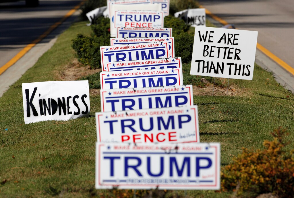 Protest signs urging more civility in American politics flank a long row of signs supporting Republican President candidate Donald Trump in Hillsborough, North Carolina, U.S., November 4, 2016. REUTERS/Jonathan Drake TPX IMAGES OF THE DAY - RTX2RZ3O