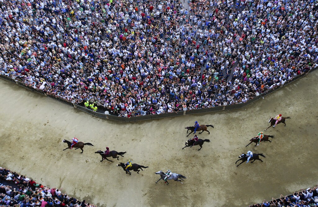 Horses race during the general practice session for the Palio di Siena horse race in Siena, Italy, July 1, 2015. Each July 2 and August 16, almost without fail since the mid-1600s, 10 riders have hurtled bareback around Siena's shell-shaped central square in a desperate bid to win the Palio, a silk banner depicting the Madonna and child. REUTERS/ Max Rossi TPX IMAGES OF THE DAY ATTENTION EDITORS - FOR EDITORIAL USE ONLY. NOT FOR SALE FOR MARKETING OR ADVERTISING CAMPAIGNS. - GF10000146023