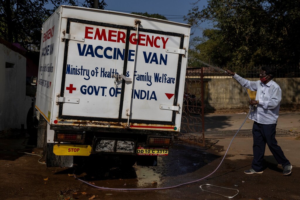 A health department driver washes a vaccine van before transporting the vaccine developed by Oxford/AstraZeneca to various vaccination centres from a regional vaccine store, during the coronavirus disease (COVID-19) pandemic, in Koraput, India, January 14, 2021. REUTERS/Danish Siddiqui SEARCH "SIDDIQUI OXFORD/ASTRAZENECA" FOR THIS STORY. SEARCH "WIDER IMAGE" FOR ALL STORIES - RC2SEL9A0XKB