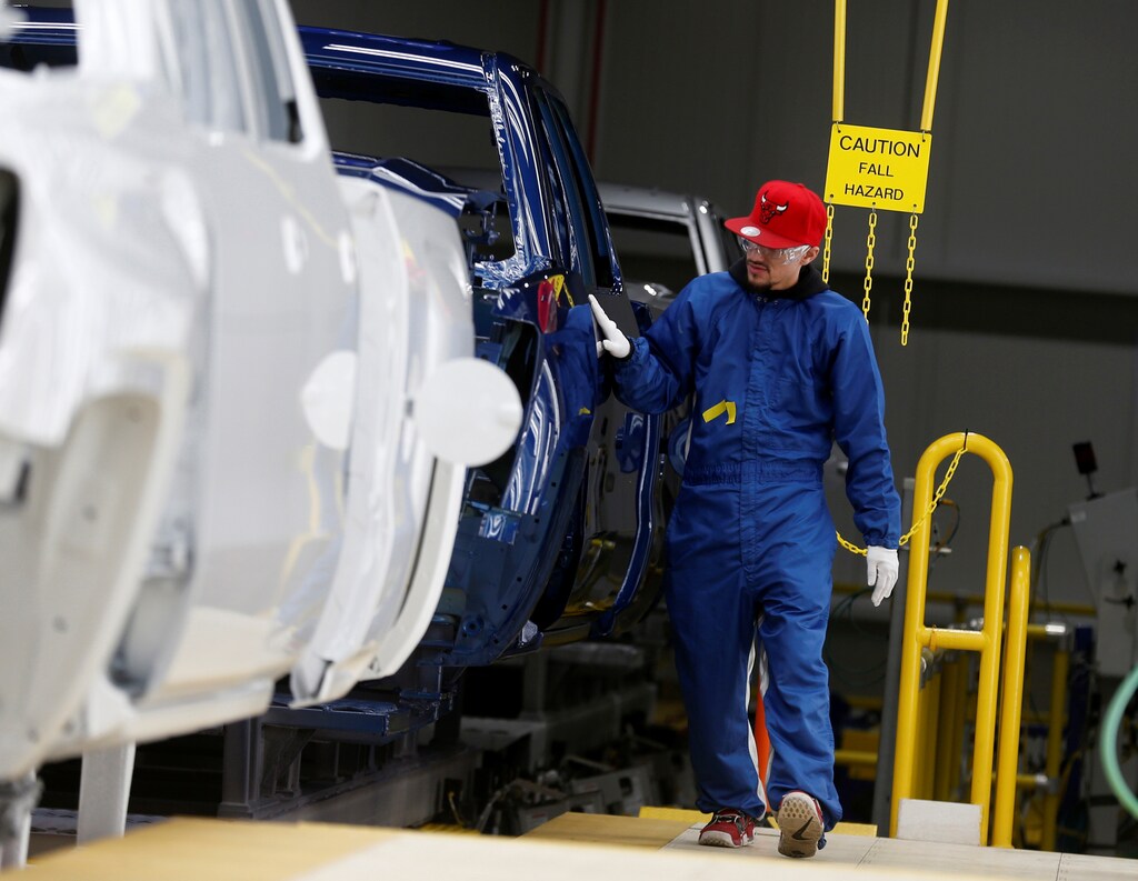 A General Motors Co. assembly worker does quality control checks on the paint of Chevrolet 2019 heavy-duty pickup trucks at the GM Flint Assembly Plant in Flint, Michigan, U.S. February 5, 2019. REUTERS/Rebecca Cook - RC18C850F9B0