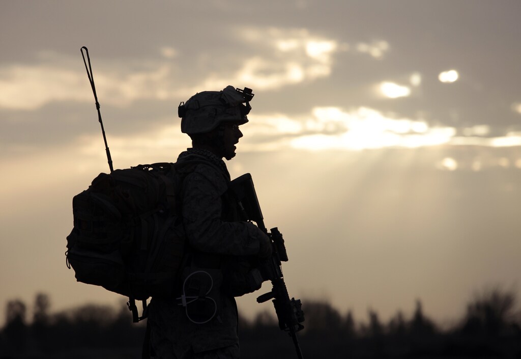 A US Marine from Bravo Company of the 1st Battalion, 6th Marines walks during an operation in Marjah, Helmand province February 21, 2010. NATO forces are facing strong resistance eight days into a major offensive in southern Afghanistan as Taliban fighters dig in to fight to the death. REUTERS/Goran Tomasevic (AFGHANISTAN - Tags: MILITARY CONFLICT) - GM1E62M06MZ01