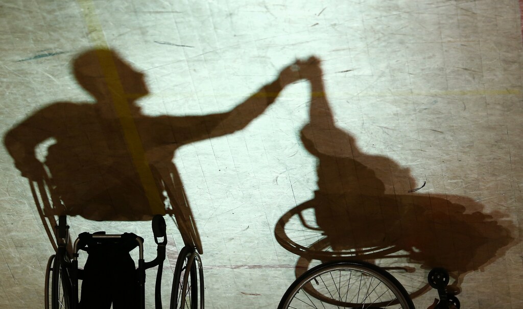 Shadow cast by a pair dancing on wheelchairs during IPC Wheelchair Dance Sport European Championships in Lomianki near Warsaw, November 9, 2014. Picture was flipped horizontally. REUTERS/Kacper Pempel (POLAND - Tags: SPORT SOCIETY) - RTR4DHL1