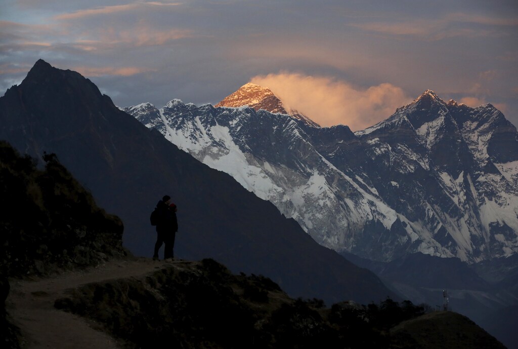 Light illuminates Mount Everest (C) during sunset in Solukhumbu district, also known as the Everest region, in this picture taken November 30, 2015. To match Insight QUAKE-NEPAL/SHERPAS REUTERS/Navesh Chitrakar - GF10000266324