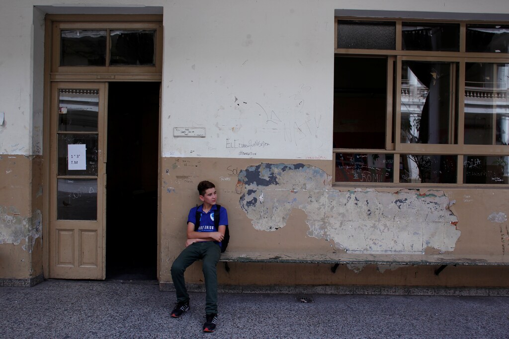 A student sits outside an empty classroom as thousands of teachers took to the streets, delaying the first day of school for millions of children, as part of a two-day national strike demanding a wage increase, in Buenos Aires, Argentina March 6, 2017. REUTERS/Martin Acosta - RTS11OYQ
