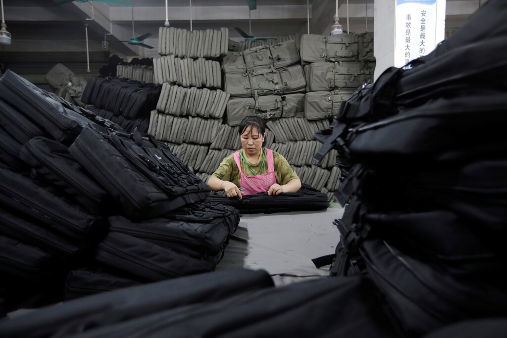 A woman works on gun cases in a factory of firearm equipment manufacturer Yakeda Tactical Gear Co, which exports most of its products to the United States, in Guangzhou, Guangdong province, China June 1, 2019. Picture taken June 1, 2019. REUTERS/Jason Lee? - RC11B43C1550