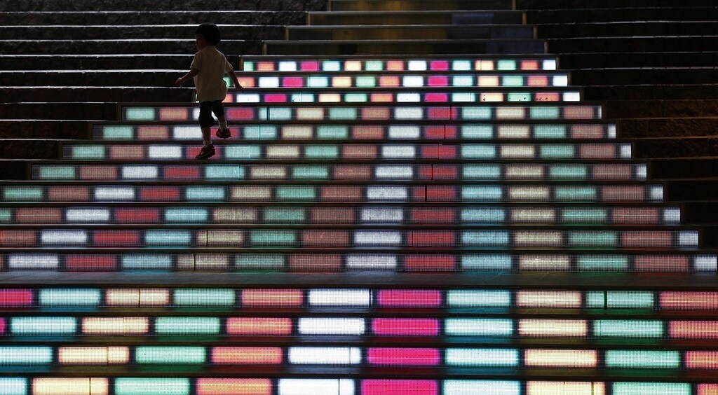 A boy walks on Media Stairs, an urban decorative feature consisting of 19 steps with video images and computer graphics projected on them, at a business district in Tokyo June 11, 2012. REUTERS/Kim Kyung-Hoon (JAPAN - Tags: SOCIETY SCIENCE TECHNOLOGY) - RTR33F80