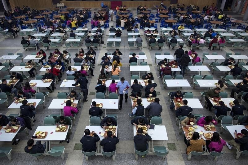 Workers eat their lunch at a restaurant inside a Foxconn factory in the township of Longhua in Shenzhen, Guangdong province January 21, 2015. REUTERS/Tyrone Siu (CHINA - Tags: BUSINESS FOOD SOCIETY INDUSTRIAL SCIENCE TECHNOLOGY) - GM1EB1L1M8701