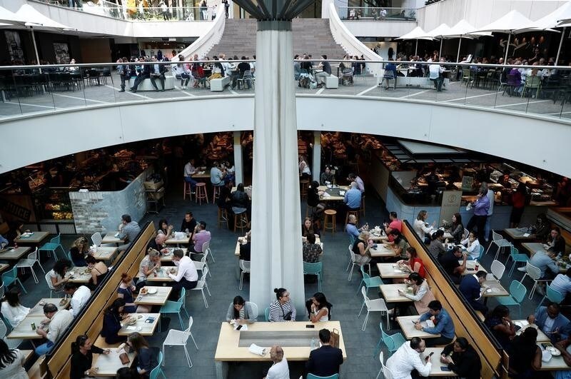 Office workers take their lunch at a food court in Sydney, Australia May 4, 2018.