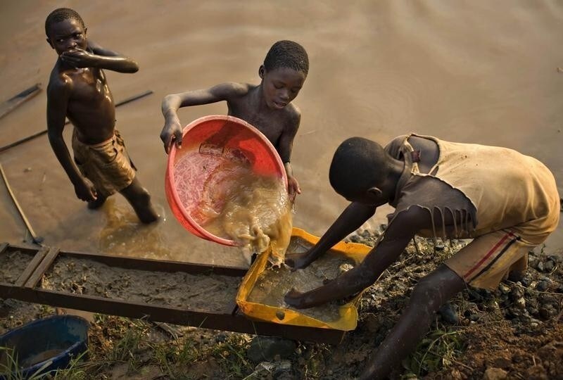 Boys pan for gold on a riverside at Iga Barriere, 25 km (15 miles) from Bunia, in the resource-rich Ituri region of eastern Congo