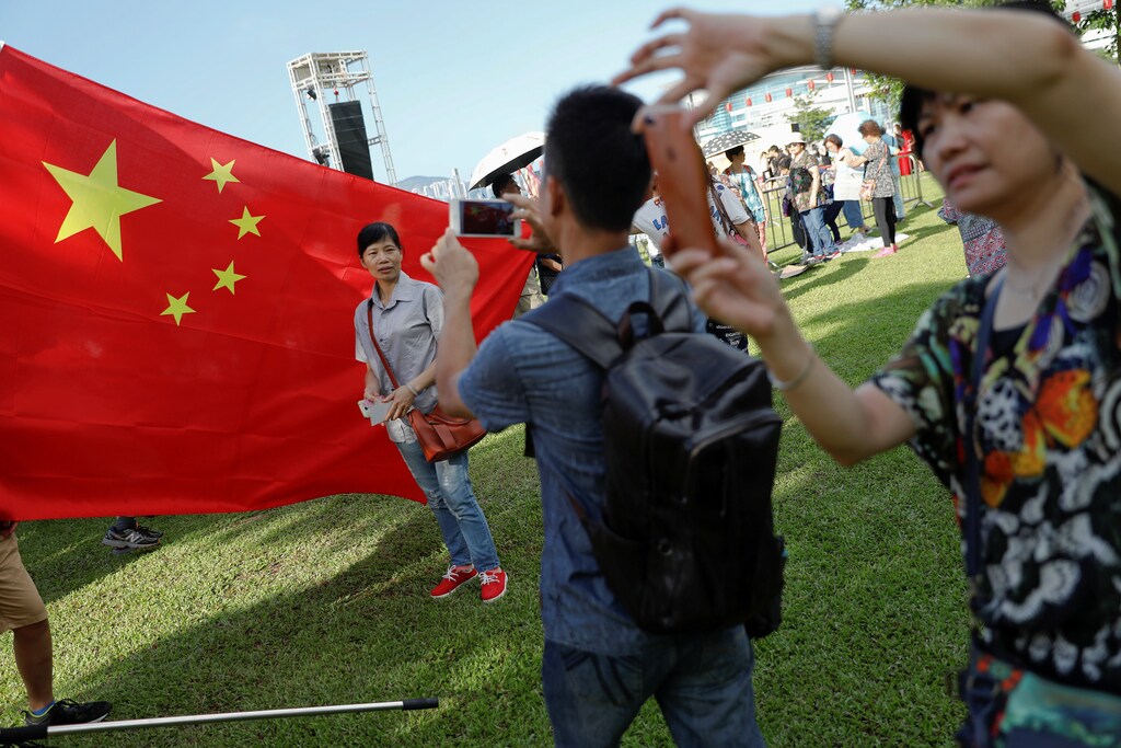 People take pictures of themselves as pro-China supporters gather during celebration marking the 20th anniversary of city's handover from British to Chinese rule, in Hong Kong, China June 29, 2017. REUTERS/Damir Sagolj - RTS193L3