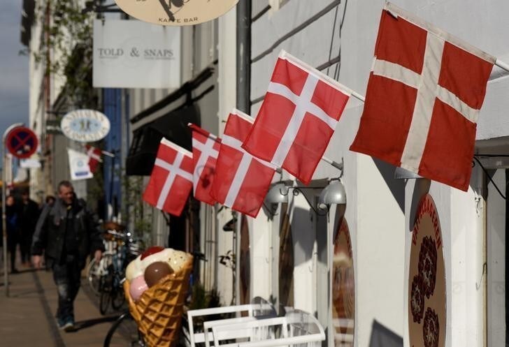 Danish flags are pictured outside a cafe at the famous landmark Nyhavn in Copenhagen, Denmark April 18, 2017. REUTERS/Fabian Bimmer