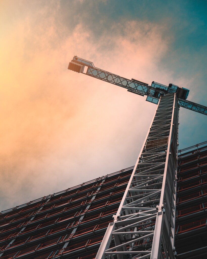 A crane from below, sky above; Fresh angle, different take, construction, sustainable infrastructure
