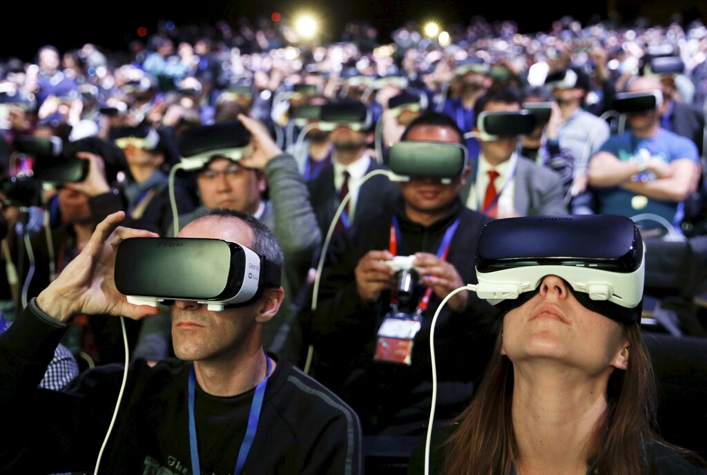 People wear Samsung Gear VR devices as they attend the launching ceremony of the new Samsung S7 and S7 edge smartphones during the Mobile World Congress in Barcelona, Spain, February 21, 2016.