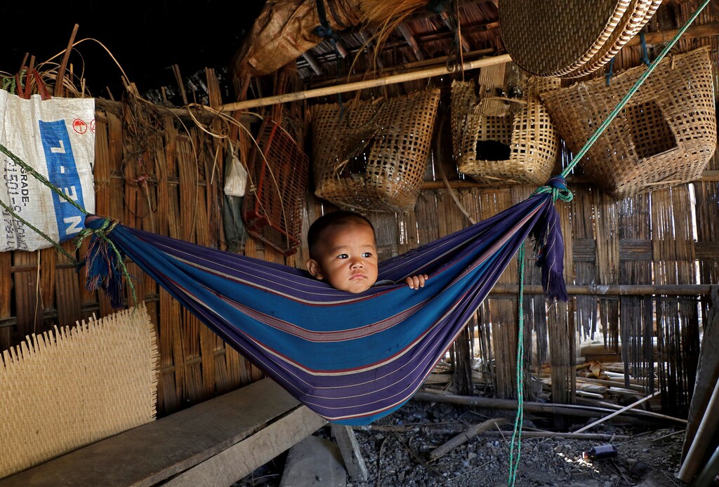 Tina Chakma, a six-month-old baby girl plays in an improvised hammock inside her parents' house on the outskirts of Agartala, India, March 20, 2018. REUTERS/Jayanta Dey TPX IMAGES OF THE DAY - RC16F46A4C00