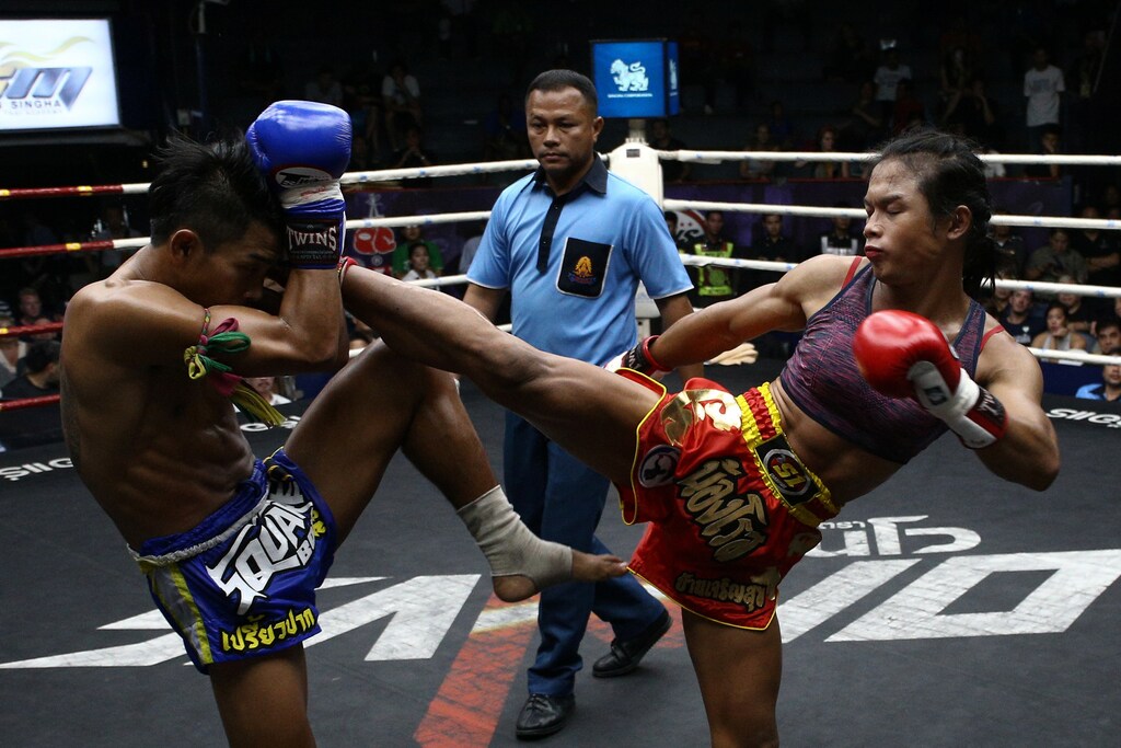 Muay Thai boxer Nong Rose Baan Charoensuk (R), 21, who is transgender, kicks Priewpak Sorjor Wichit-Padrew during a boxing match at the Rajadamnern Stadium in Bangkok, Thailand, July 13, 2017. REUTERS/Athit Perawongmetha SEARCH "TRANSGENDER BOXER" FOR THIS STORY. SEARCH "WIDER IMAGE" FOR ALL STORIES. TPX IMAGES OF THE DAY. - RTX3CRBF
