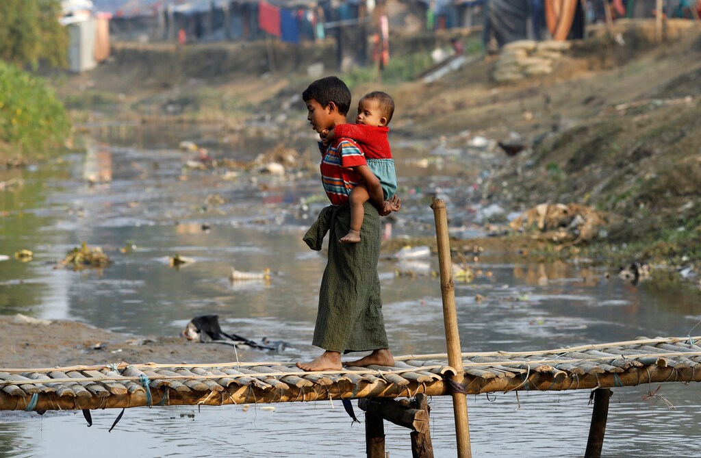 Two Rohingya refugee children on a bridge from no-man's land to Bangladesh, at the Bangladesh-Myanmar border.