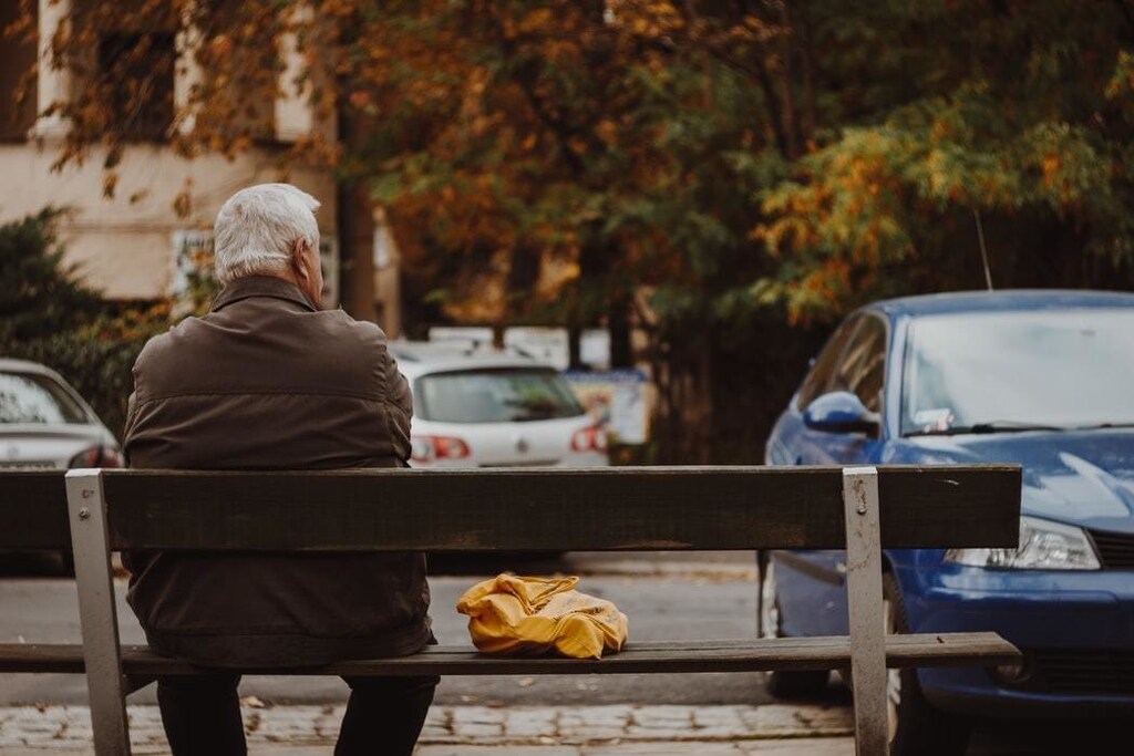 Image of elderly person sitting along