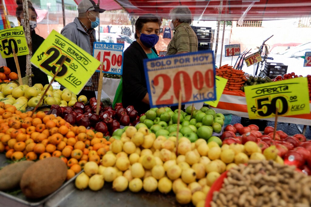 Customers walk past a fruit stall at a street market, in Mexico City, Mexico.