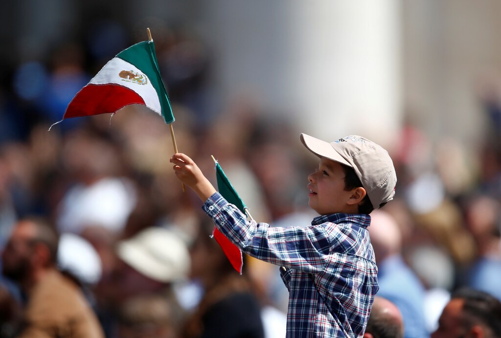 A child waves a Mexican flag as Pope Francis leads the Angelus prayer in Saint Peter's Square at the Vatican April 23, 2017. REUTERS/Tony Gentile - RTS13IPH