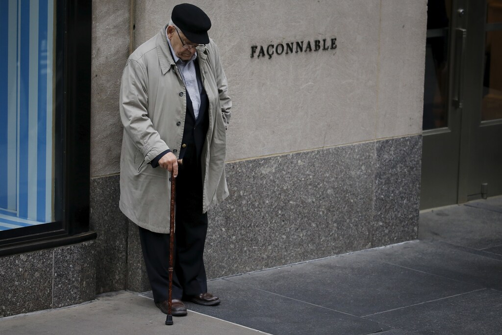 A man bows his head as he listens on speakers outside St. Patrick's church to New York Police Department officer Joseph Lemm's funeral in the Manhattan borough of New York, December 30, 2015. Lemm was one of six U.S. troops killed by a suicide bomber near Bagram air base in Afghanistan. REUTERS/Carlo Allegri - GF10000279149
