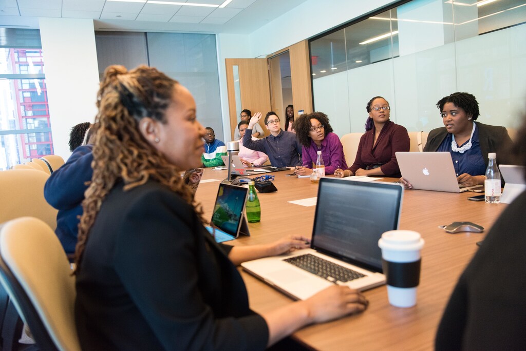 people in an office boardroom discussing a new project