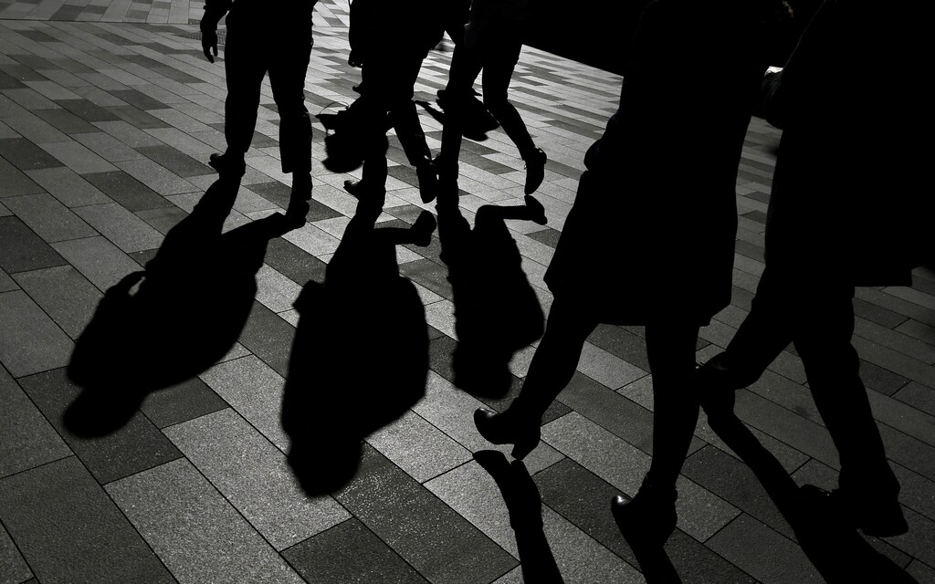FILE PHOTO: Workers cast shadows as they stroll among the office towers Sydney's Barangaroo business district in Australia's largest city, May 8, 2017. REUTERS/Jason Reed/File Photo