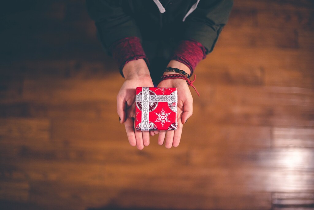 Somebody offering a wrapped present