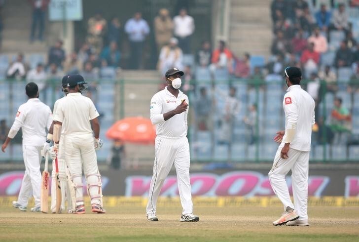 Cricket - India v Sri Lanka- Third Test Match - Feroz Shah Kotla, New Delhi - December 5, 2017 - A Sri Lankan player, wearing a face mask, gestures as he walks in the field. REUTERS/Stringer