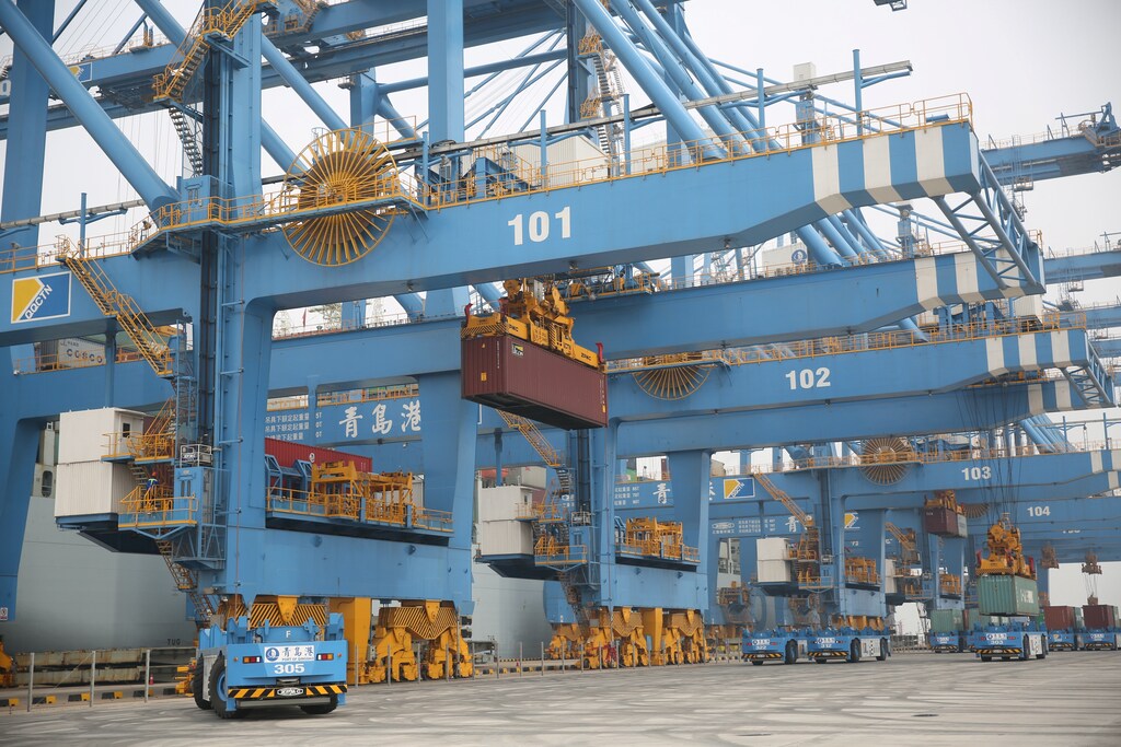 Automated guided vehicles (AGV) operate at an automated container terminal in Qingdao Port, Shandong province, China