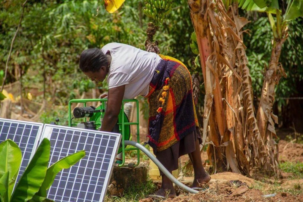 A Kenyan farmer sets up her solar irrigation pump in Busia county, Kenya on February, 2019.