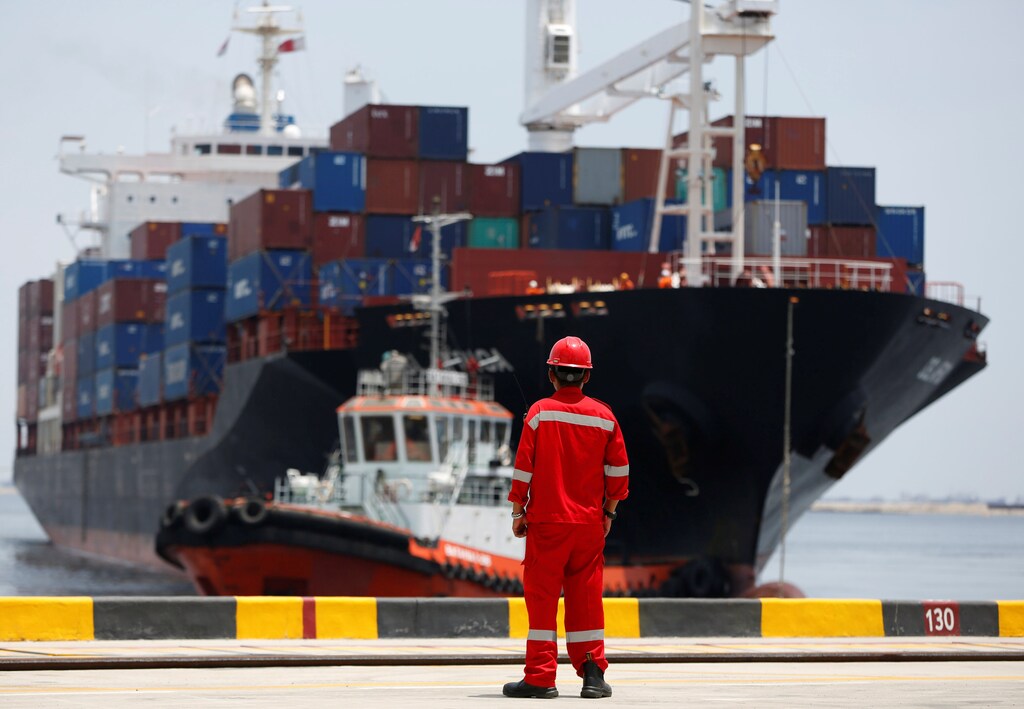 A port worker watches as a ship leaves the New Priok Container Terminal 1 in North Jakarta, Indonesia September 13, 2016