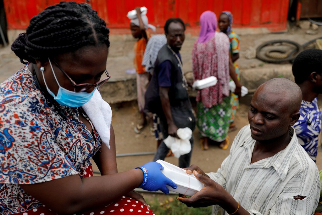 A volunteer distributes cooked food and water to the underprivileged and homeless, as Ghana enforces a partial lockdown in Accra and Kumasi in efforts to slow the spread of the coronavirus disease (COVID-19), in Accra, Ghana. April 4, 2020. REUTERS/Francis Kokoroko - Coronavirus china virus health healthcare who world health organization disease deaths pandemic epidemic worries concerns Health virus contagious contagion viruses diseases disease lab laboratory doctor health dr nurse medical medicine drugs vaccines vaccinations inoculations technology testing test medicinal biotechnology biotech biology chemistry physics Tech technology science chemistry biology physics electricity electric power battery charge positive negative lab laboratory scientist fourth industrial revolution microscope research influenza flu cold common cold bug risk symptomes respiratory china iran italy europe asia america south america north washing hands wash hands coughs sneezes spread spreading precaution precautions health warning covid 19 cov SARS 2019ncov wuhan sarscow wuhanpneumonia pneumonia outbreak patients unhealthy fatality mortality elderly old elder age serious death deathly deadly Africa populations malawi Lilongwe Ouagadougou Burkina Faso Uige Angola Bobo-Dioulasso Burkina Faso Dar es Salaam Tanzania Tete Mozambique Niamey Niger Bunia Congo Gwagwalada Nigeria Mwanza Tanzania Songea Tanzania Kabinda Congo Kampala Uganda Zinder Niger Bujumbura Burundi cities smart urban urbanization development growth growing inclusive inclusivity poverty tech technology science data electricity electric power fourth industrial revolution 4ir progress advancement power new revolutionary robot robotics ai artificial intelligence machine learning