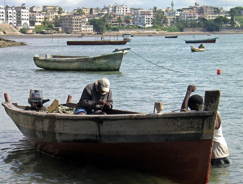 image of Kenyan fishermen sitting in their boats in the port of Mombasa Old Town, Kenya