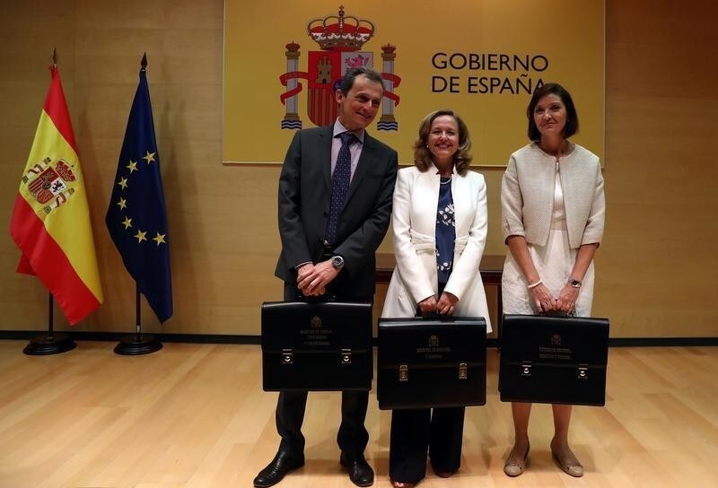 Spain's new Science, Innovation and Universities Minister Pedro Duque, Economy Minister Nadia Calvino and Industry Minister Reyes Maroto pose with their ministerial briefcases during the taking over ceremony at the Ministry of Economy in Madrid, Spain, June 7, 2018.