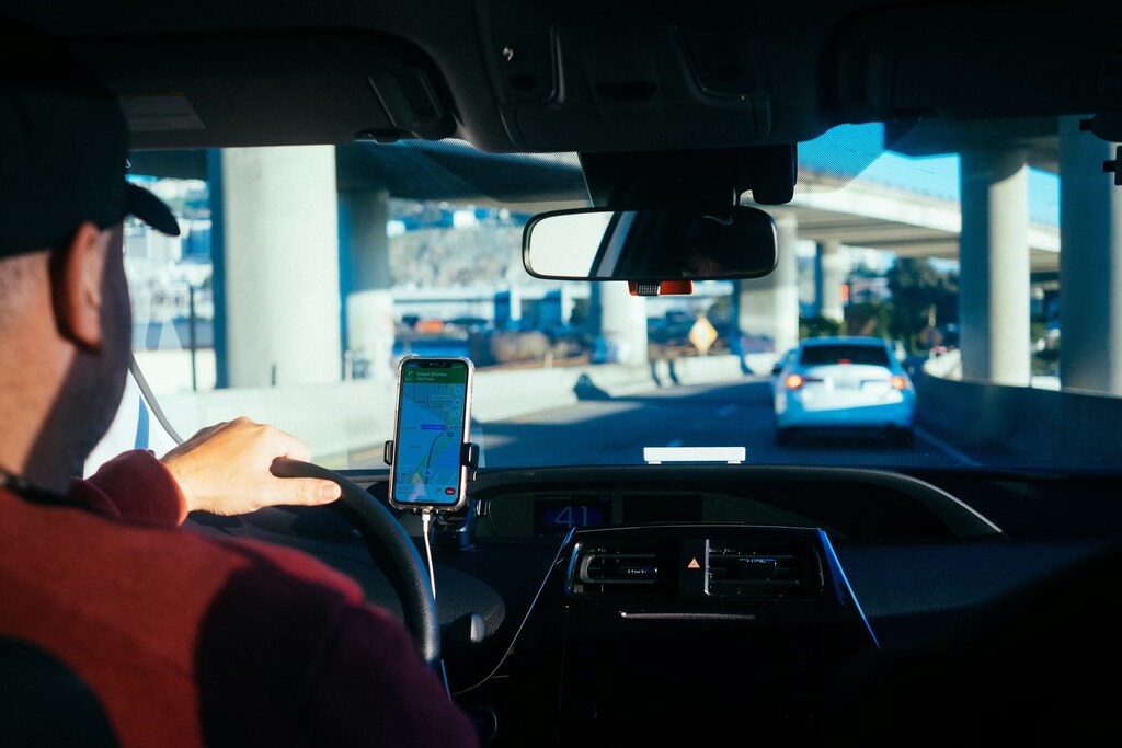 Driver with phone navigation system: Asia is at the forefront of the global gig economy