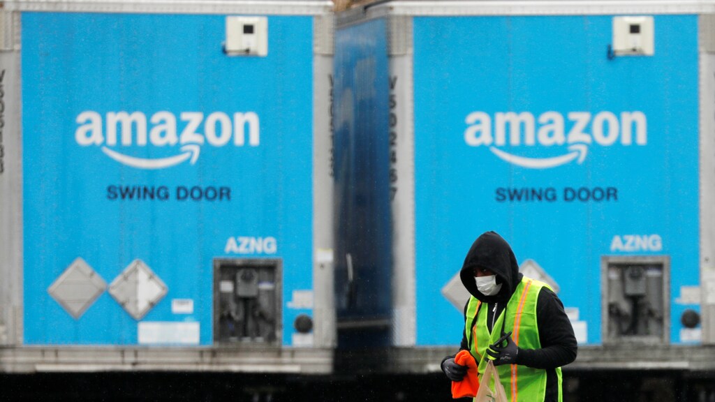 A worker in a face mask walks by trucks parked at an Amazon facility as the global coronavirus outbreak continued in Bethpage on Long Island in New York, U.S., March Coronavirus china virus health healthcare who world health organization disease deaths pandemic epidemic worries concerns Health virus contagious contagion viruses diseases disease lab laboratory doctor health dr nurse medical medicine drugs vaccines vaccinations inoculations technology testing test medicinal biotechnology biotech biology chemistry physics microscope research influenza flu cold common cold bug risk symptomes respiratory china iran italy europe asia america south america north washing hands wash hands coughs sneezes spread spreading precaution precautions health warning covid 19 cov SARS 2019ncov wuhan sarscow wuhanpneumonia pneumonia outbreak patients unhealthy fatality mortality elderly old elder age serious death deathly deadly