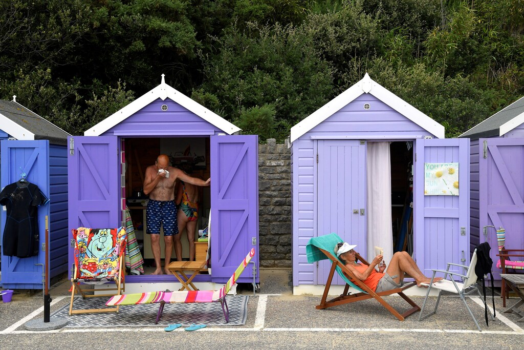 People relax as they enjoy the sunny weather at the Bournemouth Beach, amid the coronavirus disease (COVID-19) outbreak, in Bournemouth, Britain July 31, 2020. REUTERS/Toby Melville - RC2E4I9LXXK8