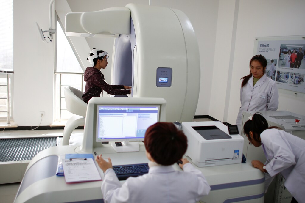 Medical staff demonstrate a HRA screening machine in Qinhuangdao, Hebei province, China.