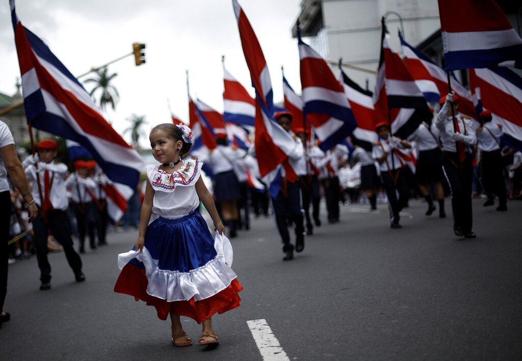 A girl wearing a dress with the colours of Costa Rica's flag takes part in a parade to commemorate Costa Rica's Independence Day in San Jose, Costa Rica.
