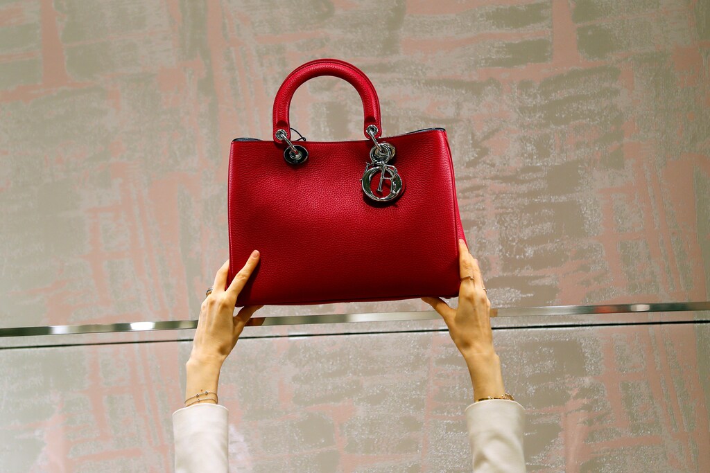 A shop assistant adjusts a Dior handbag at Dior's new flagship store in London, Britain, May 31, 2016. REUTERS/Stefan Wermuth - RTX2EZT6