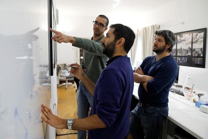 Employees of the D-ID startup company debate while looking at a whiteboard at the company's office in Tel Aviv, Israel February 7, 2018. Picture taken February 7, 2018. REUTERS/Amir Cohen