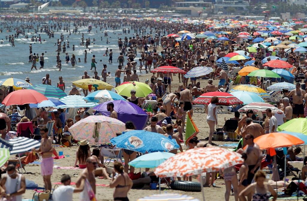 People enjoy the sunny weather at the Malvarrosa beach during the warmest weekend of the year so far, with temperatures over 30 degrees Celsius, in Valencia, Spain June 11, 2017. REUTERS/Heino Kalis, - RTS16KHS