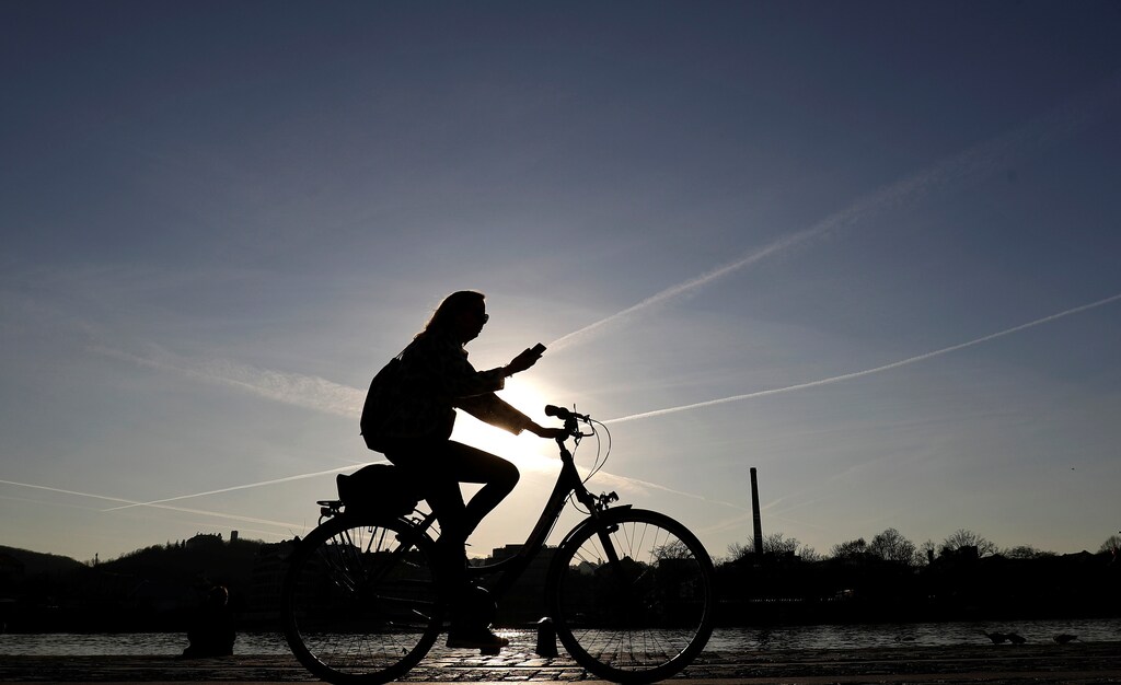 A woman rides a bike along the Vltava river bank in Prague, Czech Republic March 21, 2019. REUTERS/David W Cerny - RC129EAB5490