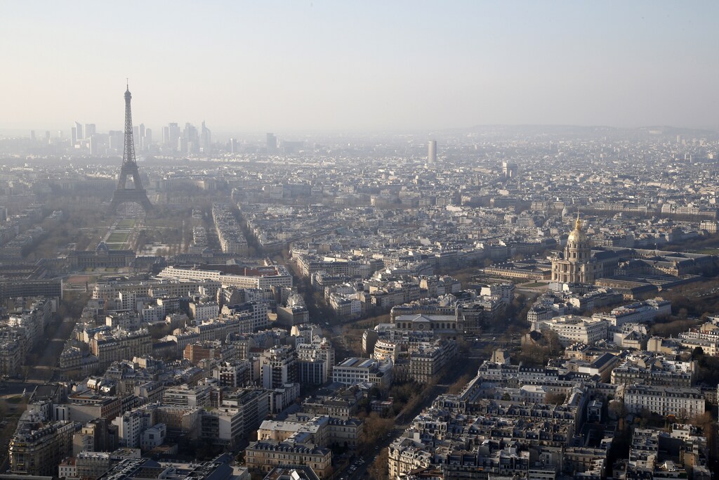 A general view of the Eiffel tower and La Defense business district skyline in the background as warm and sunny weather continues in France, March 10, 2014.