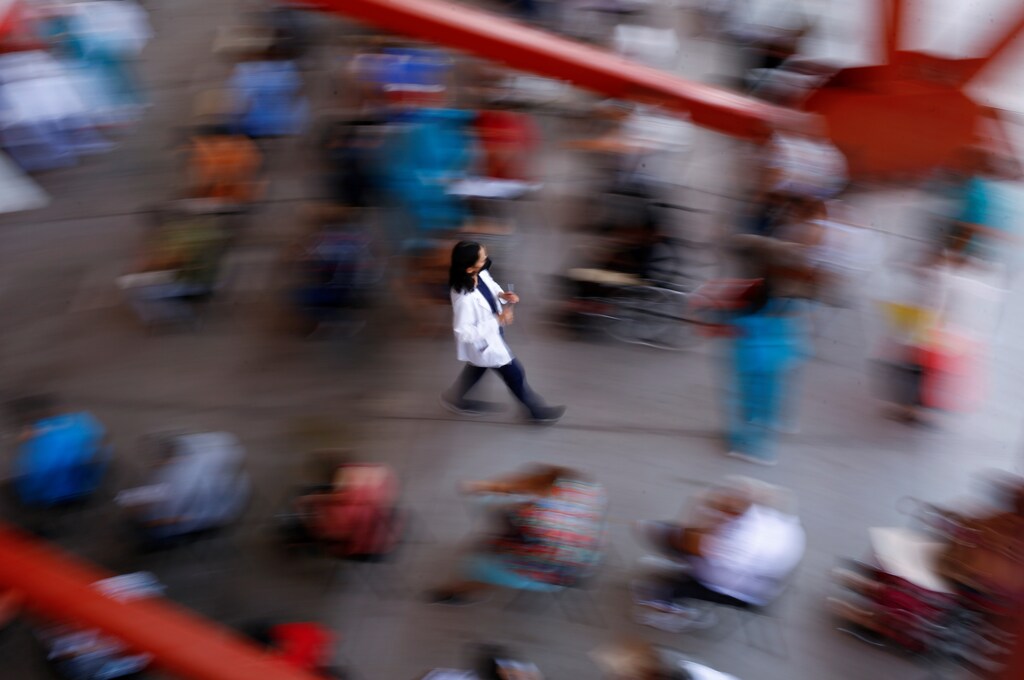 A health worker walks with a dose of the Pfizer-BioNTech coronavirus disease (COVID-19) vaccine, during a mass vaccination programme for people over 50 years of age at a baseball stadium in Ciudad Juarez, Mexico June 22, 2021. REUTERS/Jose Luis Gonzalez - RC2S5O9ZSYSN